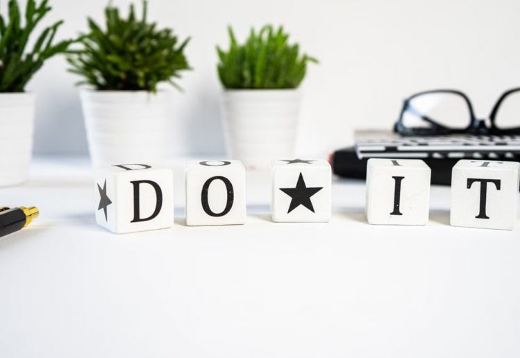 Inspiring office scene with 'Do It' blocks and plants, perfect for motivation.